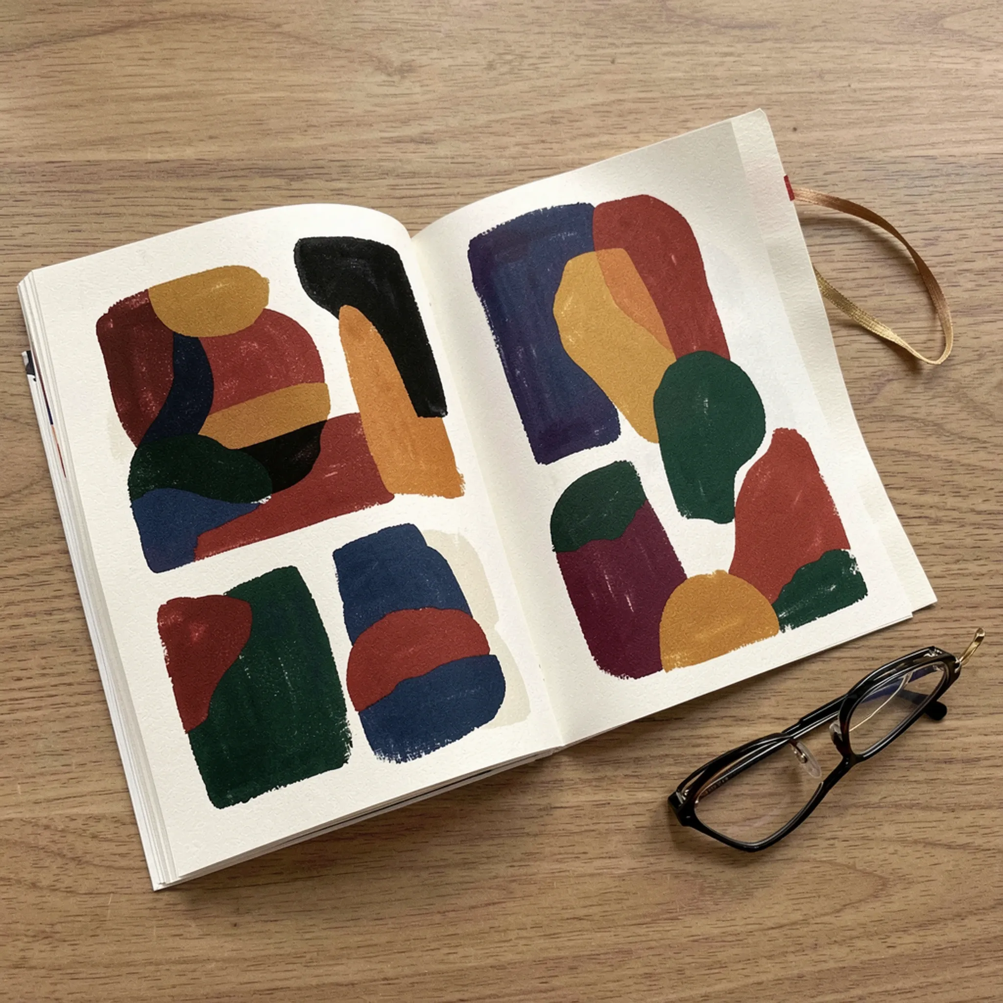 Illustration: an open printed magazine with colourful illustrated pages and a pair of reading glasses.